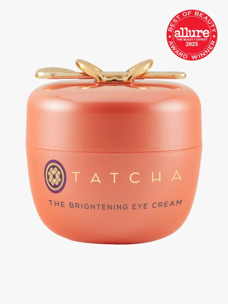 Tatcha The Brightening Eye Cream in branded orange jar with decorative cap on on light gray background with red Allure Best of Beauty seal in the top right corner